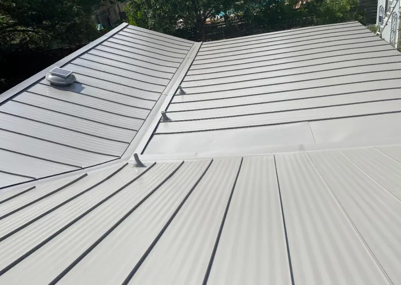 Solar attic fan installed on a metal roof for Roof Ventilation in Highland City